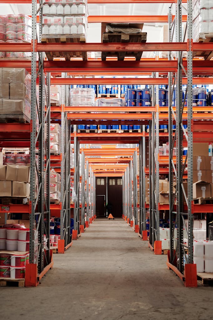 A modern warehouse interior showcasing organized shelves and pallets for efficient storage.